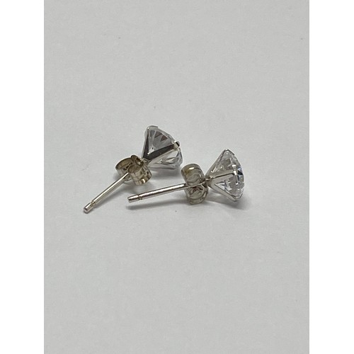 307 - A pair of 9ct white gold earrings with clear stones