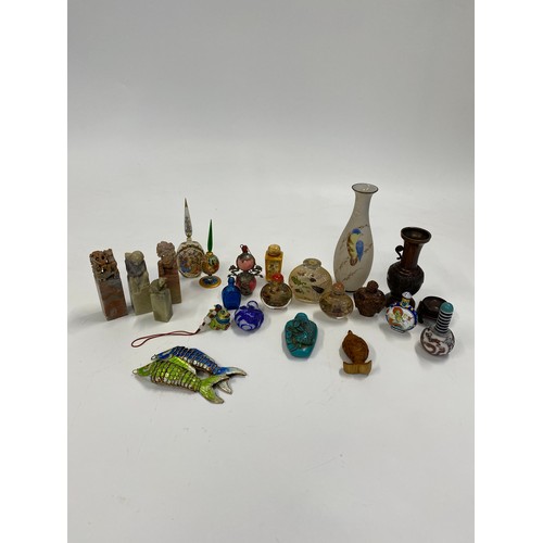 17 - A group of predominately oriental themed items consisting of snuff bottles, carved agate figures, va... 