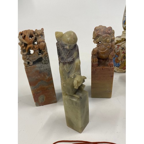 17 - A group of predominately oriental themed items consisting of snuff bottles, carved agate figures, va... 