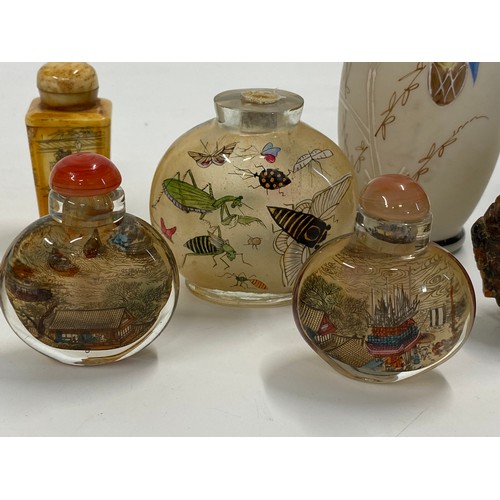 17 - A group of predominately oriental themed items consisting of snuff bottles, carved agate figures, va... 