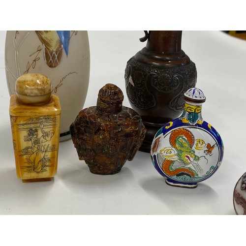 17 - A group of predominately oriental themed items consisting of snuff bottles, carved agate figures, va... 