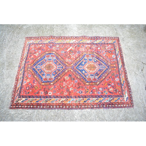 71 - Qashqai rectangular woolen rug with double lozenge design in reds and blues, size approx 144cms x 10... 