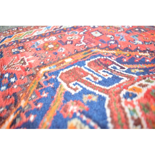 71 - Qashqai rectangular woolen rug with double lozenge design in reds and blues, size approx 144cms x 10... 