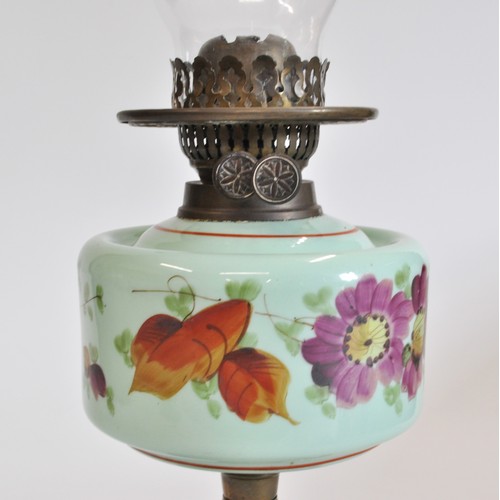 90 - Antique oil lamp with glass funnel and white glass shade, base decorated with flowers. Approx H56cms