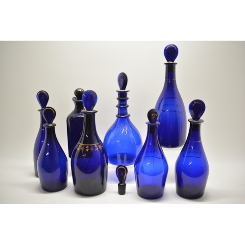 129 - Antique Georgian blue glass decanters with stoppers, handpainted gild designs Brandy, Hollands, Rum,... 