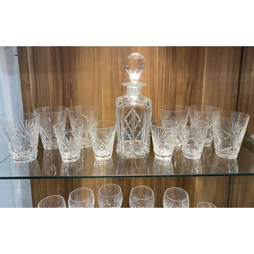 136 - Two shelves full of cut crystalware, to include a faceted decanter with mixed wine goblets and other... 