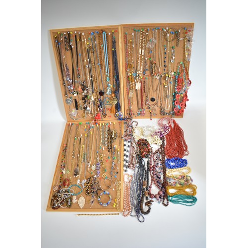 259 - A large selection of costume jewellery displayed on boards, consisting necklaces, bracelets, beads, ... 