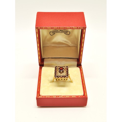 265 - 9ct yellow gold garnet cocktail ring, designed in rectangular form. Approx size R.. Gross weight 6g.