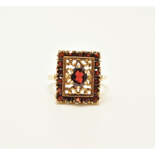 265 - 9ct yellow gold garnet cocktail ring, designed in rectangular form. Approx size R.. Gross weight 6g.