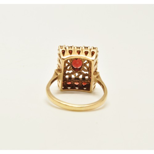 265 - 9ct yellow gold garnet cocktail ring, designed in rectangular form. Approx size R.. Gross weight 6g.