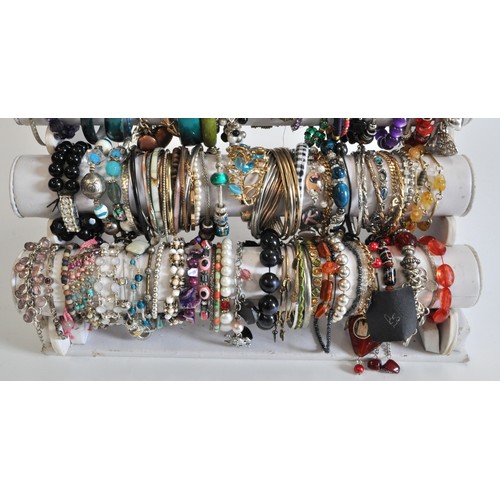 271 - x5 tiers of costume jewellery bracelets, various styles and metals, beads etc.  in excess of over 10... 