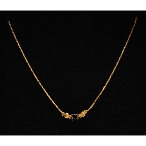 280 - Gold necklace with black stone, stamped 22k KOMKRapprox gross weight 8g.