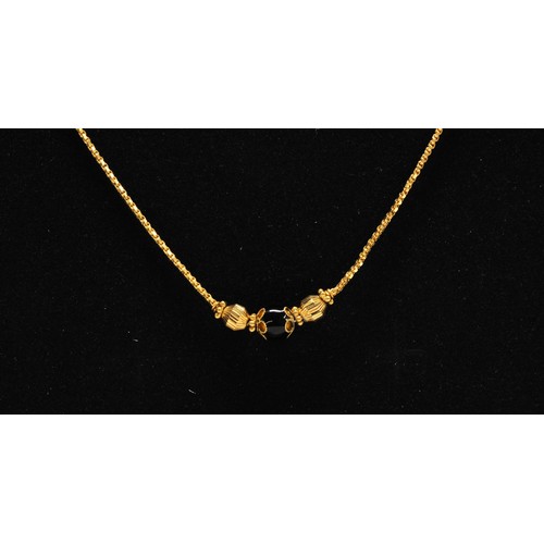 280 - Gold necklace with black stone, stamped 22k KOMKRapprox gross weight 8g.