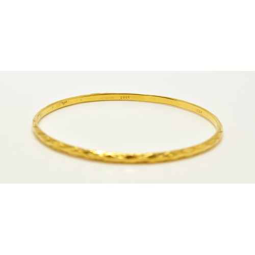 296 - Yellow gold bangles of same design, stamped 22K, approx combined gross weight 22.5g.