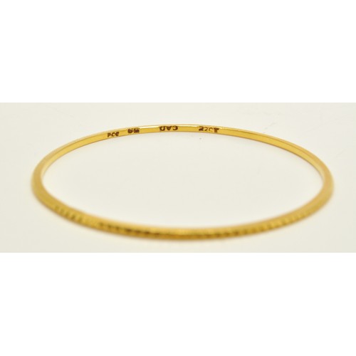 296 - Yellow gold bangles of same design, stamped 22K, approx combined gross weight 22.5g.