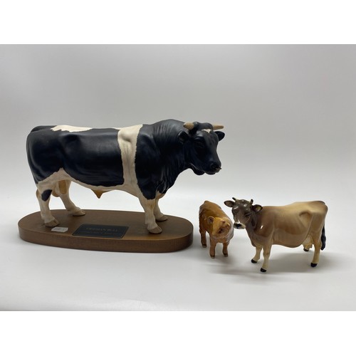 307 - Large Beswick Friessian Bull together with  Beswick Jersey cow and Beswick Highland Calf.