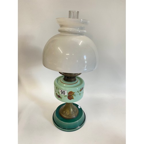 90 - Antique oil lamp with glass funnel and white glass shade, base decorated with flowers. Approx H56cms