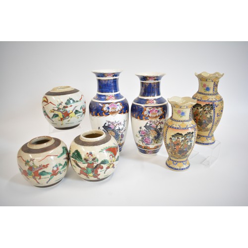 32 - Oriental items group consisting two pairs of vases, Qing Dynasty style warriors in battle famille ve... 