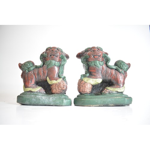 38 - A pair of heavy cast stone foo dogs with hand painted decoration approx H25cm x L25cm