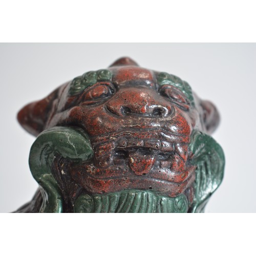 38 - A pair of heavy cast stone foo dogs with hand painted decoration approx H25cm x L25cm