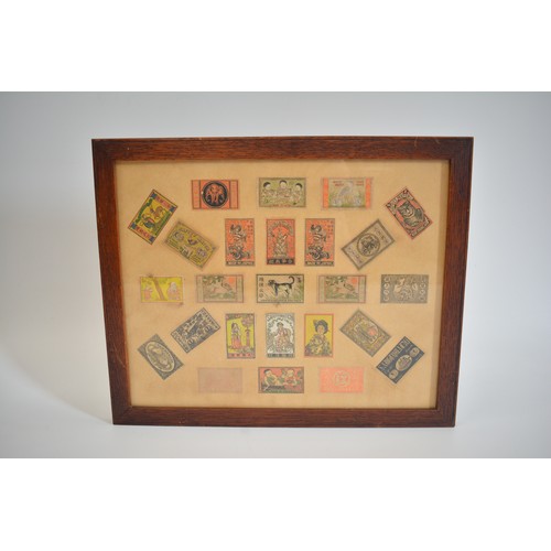 51 - Framed display of Japanese matchbox covers, approx frame size 42.5cm x 34.75cm.