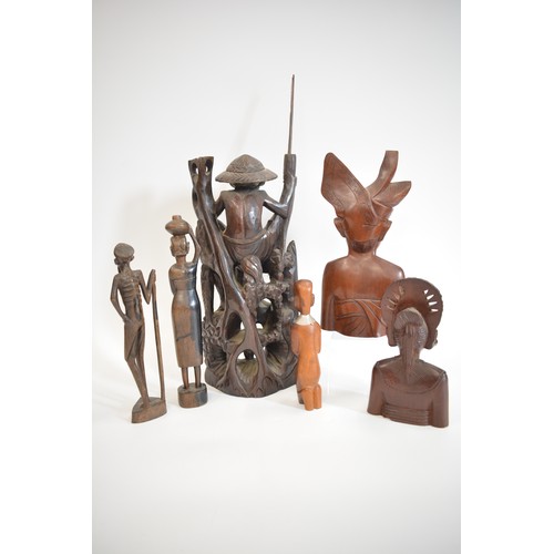 52 - A group of hand carved figures to include Asian, Balinese and African items