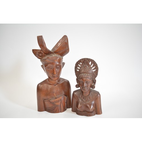 52 - A group of hand carved figures to include Asian, Balinese and African items