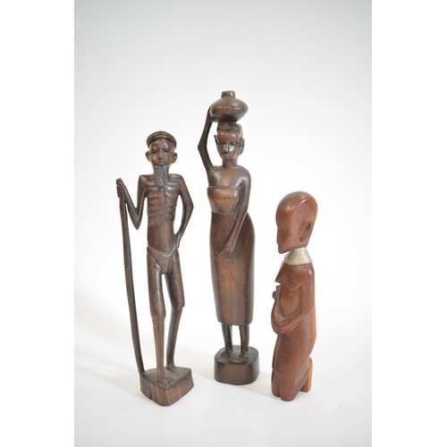 52 - A group of hand carved figures to include Asian, Balinese and African items