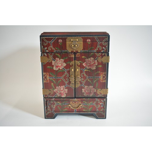 53 - Chinese table cabinet with hinged top over two doors and drawer, decorated with symmetric floral pat... 