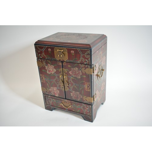 53 - Chinese table cabinet with hinged top over two doors and drawer, decorated with symmetric floral pat... 