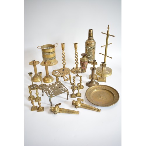 83 - A group of brassware items, to include candlesticks, trivets, wine holders,  vase with raised copper... 