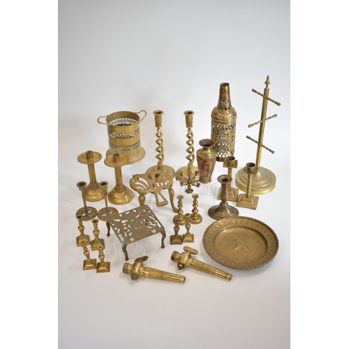 83 - A group of brassware items, to include candlesticks, trivets, wine holders,  vase with raised copper... 