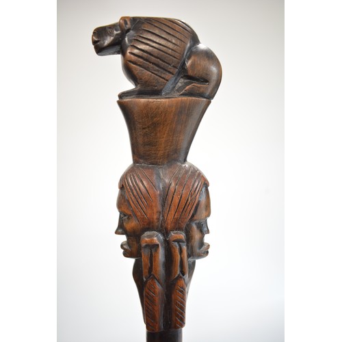 93 - Brass stick stand containing a quantity of African, some tribal hardwood, and other walking canes an... 