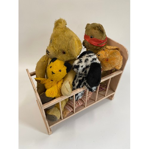 104 - A vintage cot containing Vintage pre-loved Teddy Bears, & two hand puppets