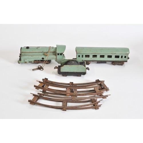 111 - Vintage tin plate green train with key and tender with coach and quantity of track