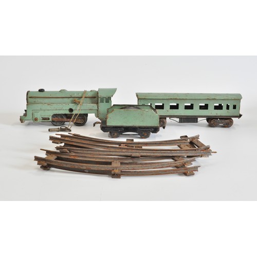 111 - Vintage tin plate green train with key and tender with coach and quantity of track