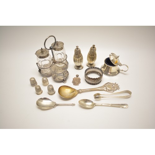 152A - A group of mixed silver items to include cruets, salt & pepers, tongs, spoons etc.