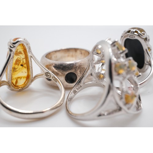 190 - x4 semi-precious rings, one tree of life design with possible yellow opal, two amber/amber style wit... 