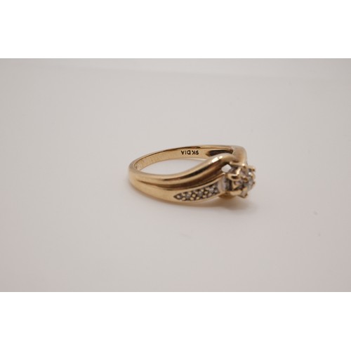 201 - 9ct yellow gold diamond ring, raised central stone with cross over design with smaller stones set in... 