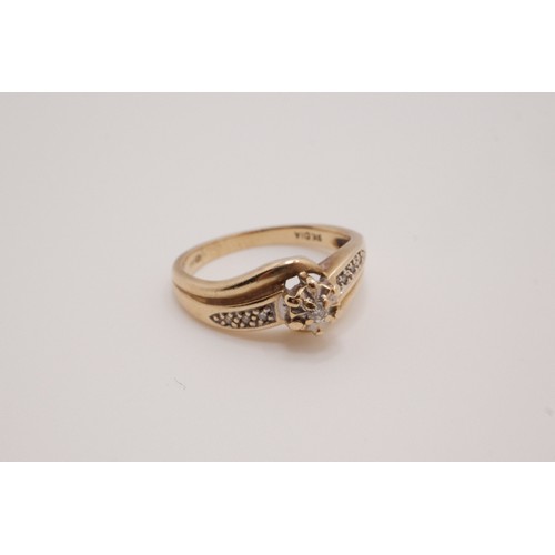 201 - 9ct yellow gold diamond ring, raised central stone with cross over design with smaller stones set in... 