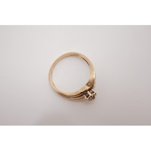 201 - 9ct yellow gold diamond ring, raised central stone with cross over design with smaller stones set in... 