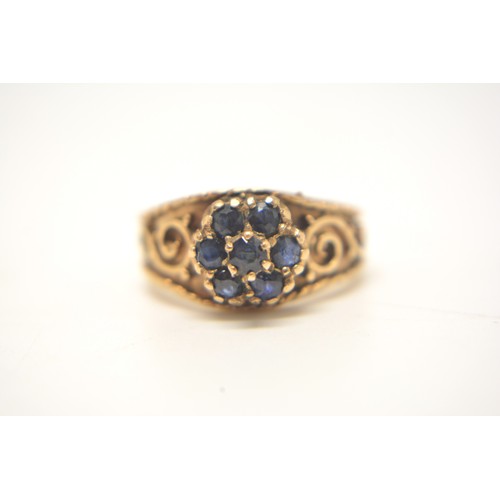 203 - 9ct yellow gold  sapphire cluster ring, scroll decoration to mount, size L/M