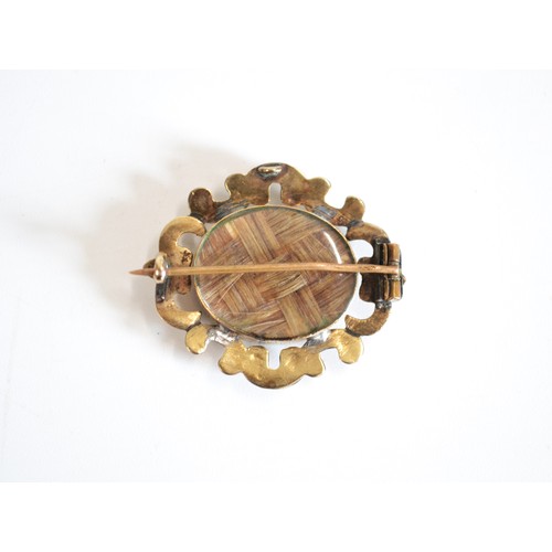 112 - Victorian mourning pin brooch with intracately woven hair encapsulated front and back, believed to b... 