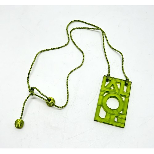 118 - Lalique Lime Green Glass Rectangular Pendant with green cord,  formed from the letters of Lalique to... 