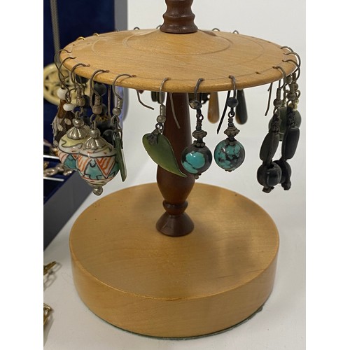 120 - Mixture of costume jewellery items including necklaces, bangles, pendants and earrings, plus stands.