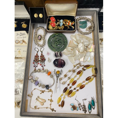 124 - Large suedette jewellery box containing a large quantity of costume jewellery including necklaces, b... 