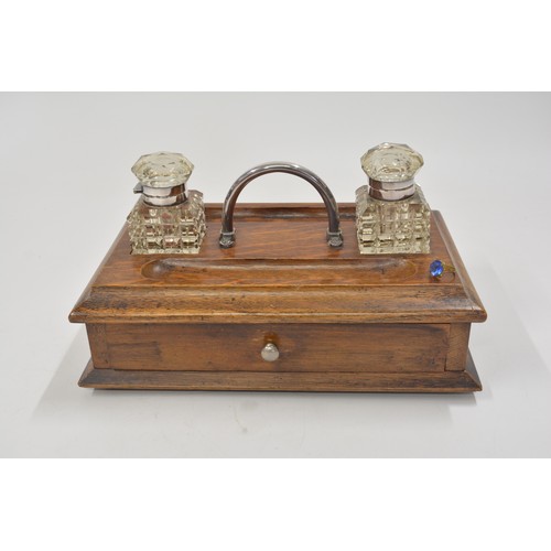 142 - Antique wooden stationery box/desk piece with cut glass inkwells, lower drawer.