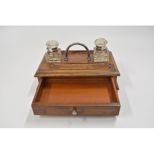 142 - Antique wooden stationery box/desk piece with cut glass inkwells, lower drawer.