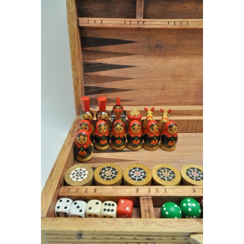 153 - Wooden chess board with carved backgammon / chess pieces in Russian doll design.