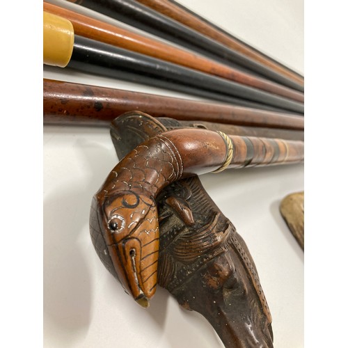 161 - A group of walking sticks / canes some with interesting finials including a carved horse head, a sna... 